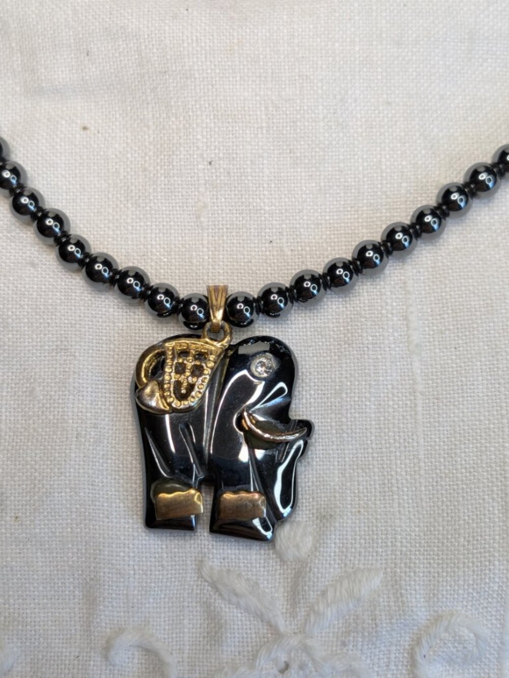 Black Hematite Elephant Necklace with Gold‑Tone Accents and Rhinestone Eye